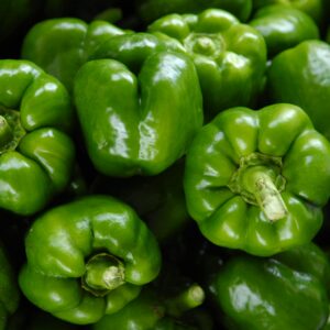 Close-up of fresh organic green bell peppers showcasing vibrant color and freshness.
