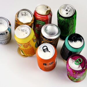 A vibrant display of various open soda cans shot from above in London, England.